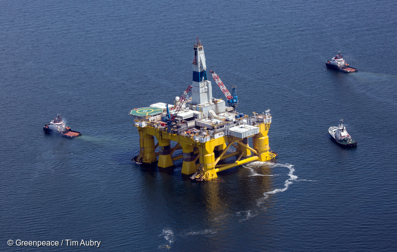 Royal Dutch Shell's offshore oil rig, the Polar Pioneer, holds off of Bainbridge, Washington in the Puget Sound as it changes tug companies on June 15, 2015.  The rig is enroute from Seattle to Alaska's Chuckchi Sea, where it will spend the summer on an… The Polar Pioneer is one of two drilling vessels heading towards the Arctic for Shell this year. The second, the Noble Discoverer, is one of the oldest drill ships in the world.   Photo by Greenpeace