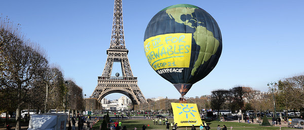 The Greenpeace hot air balloon flies in Paris in front of the Eiffel Tower. The banners underneath the balloon read "Rise up for renewables' in English and "renouvelons l'énergie" in French. This photo opportunity in Paris calls for climate action and energy from 100% renewable sources ahead of crunch climate talks in Paris.