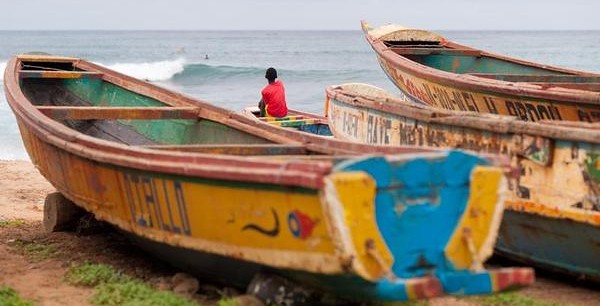 "A child on a artisanal fishing pirogue at the fishing port of Ouakam, Dakar."