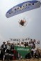 A paragliding pilot flies over Greenpeace